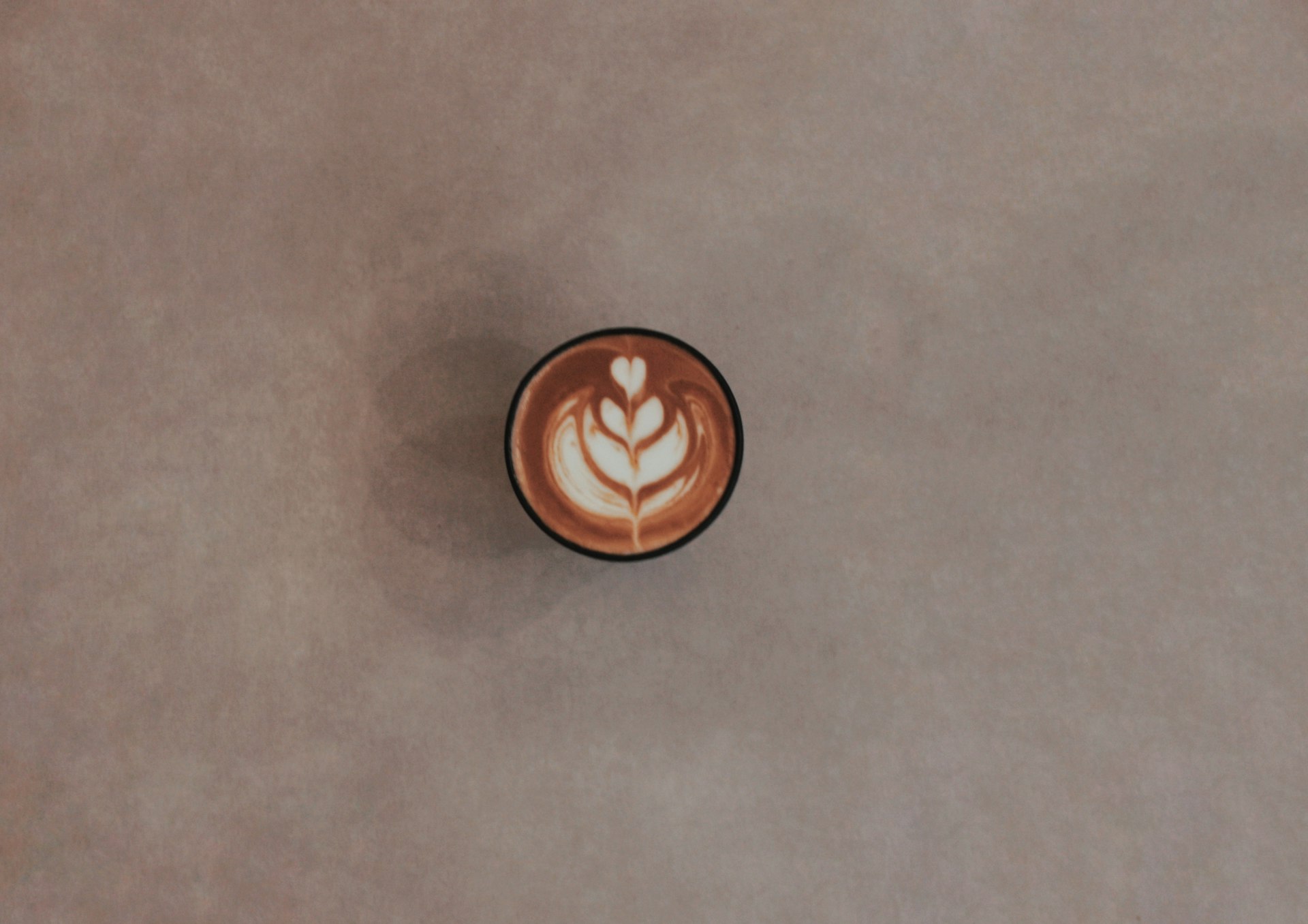 brown ceramic mug on gray table